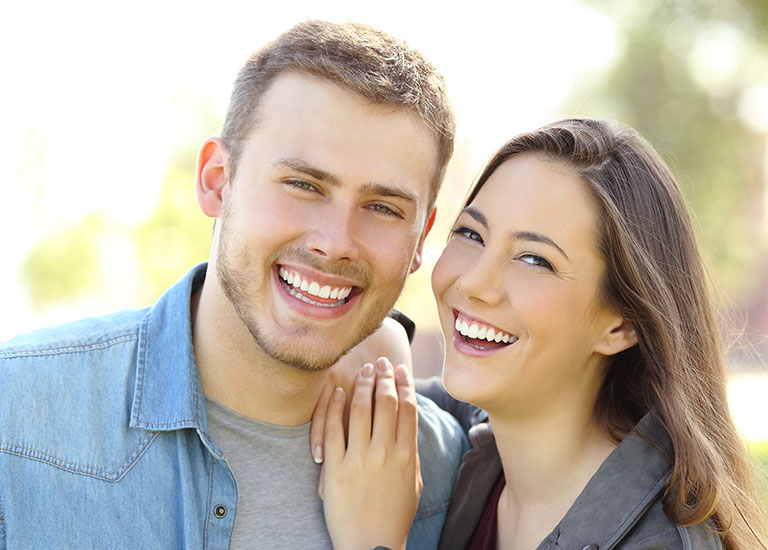 couple outdoors smiling beautiful smiles Cosmetic Dentistry Chicago, IL Chicago Loop